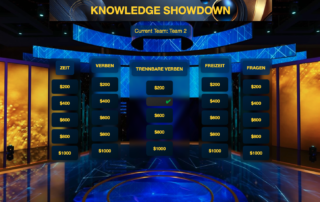 A Knowledge Showdown gameboard with five categories: Zeit, Verben, Trennbare Verben, Freizeit, and Fragen. Monetary values range from $200 to $1000, with the current team displayed as Team 2.